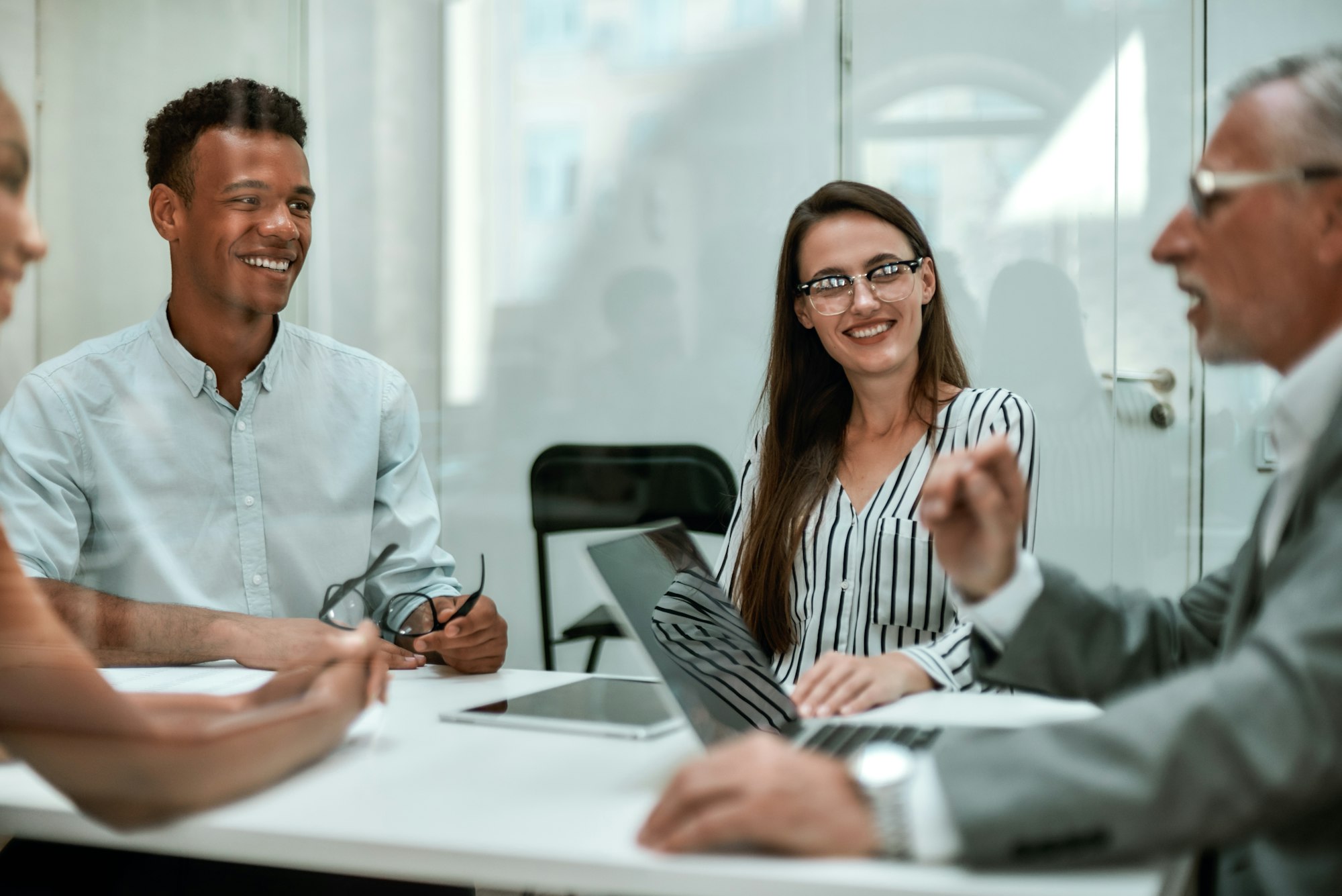 good-day-young-and-cheerful-coworkers-smiling-while-having-a-meeting-in-the-modern-office.jpg
