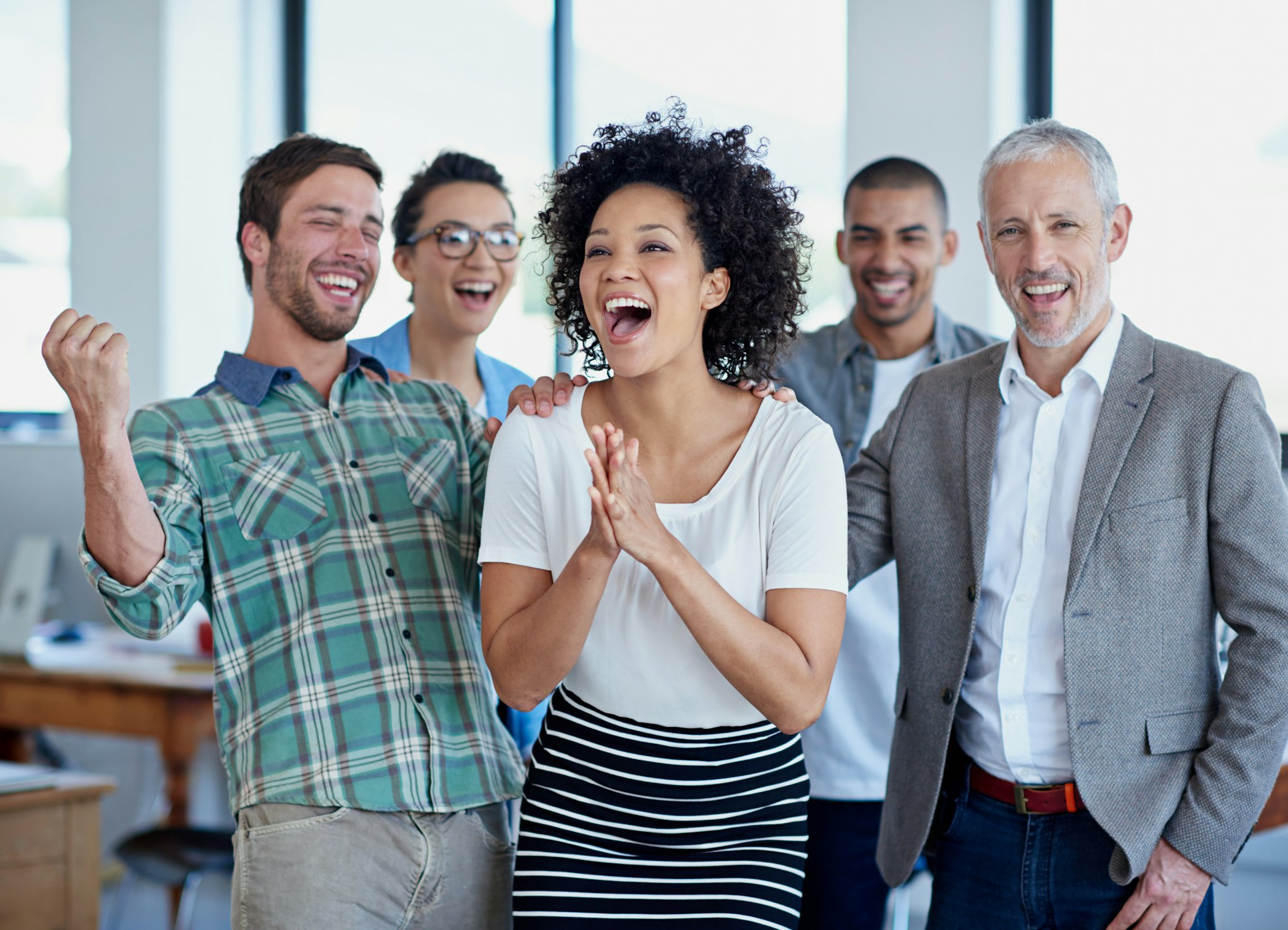 shot-of-a-group-of-happy-coworkers-celebrating-standing-in-an-office.jpg